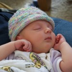 Sleeping peacefully in her knit hat